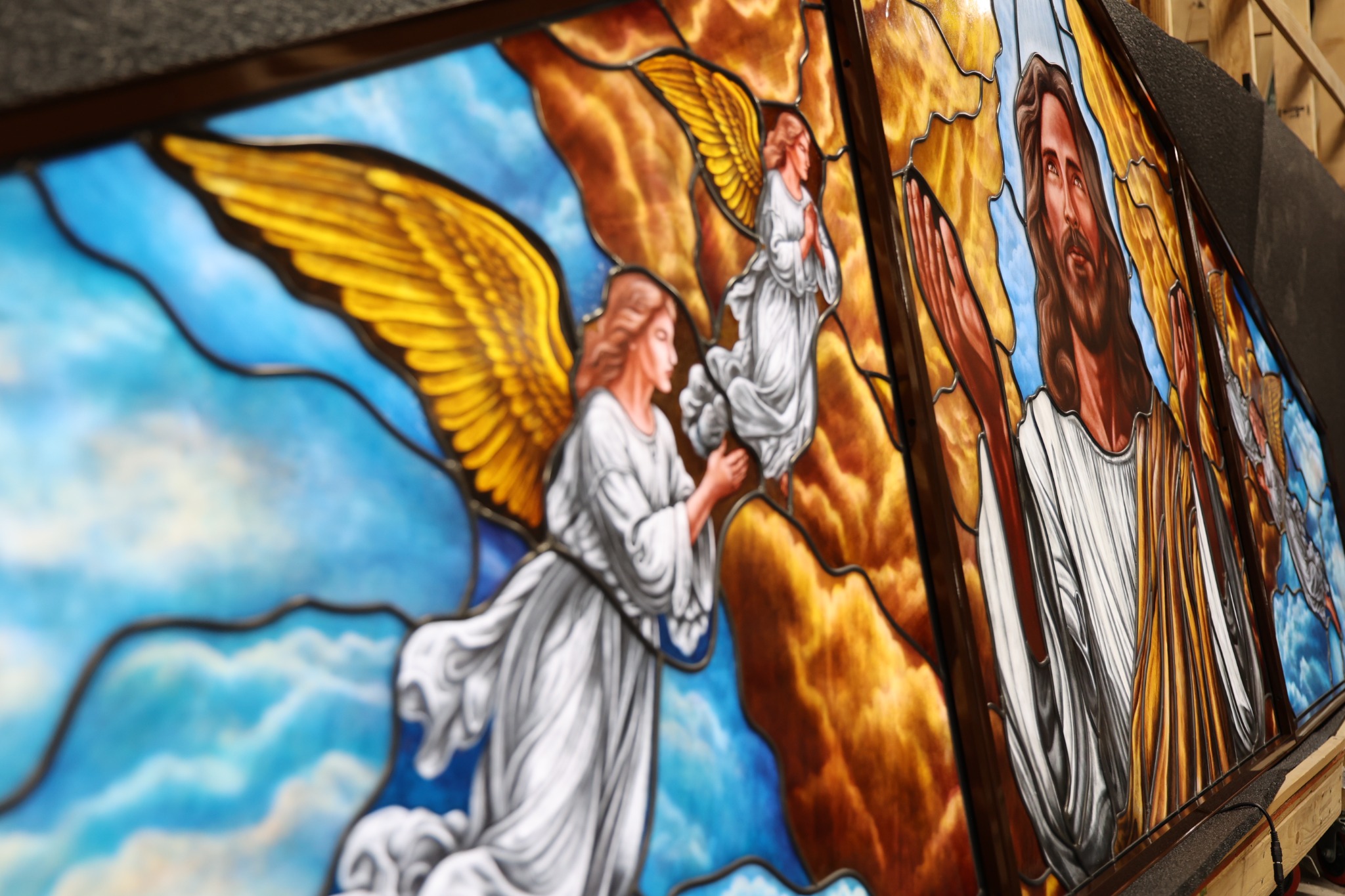 Detailed Scottish Stained Glass religious artwork featuring Christ and angels in richly painted glass.