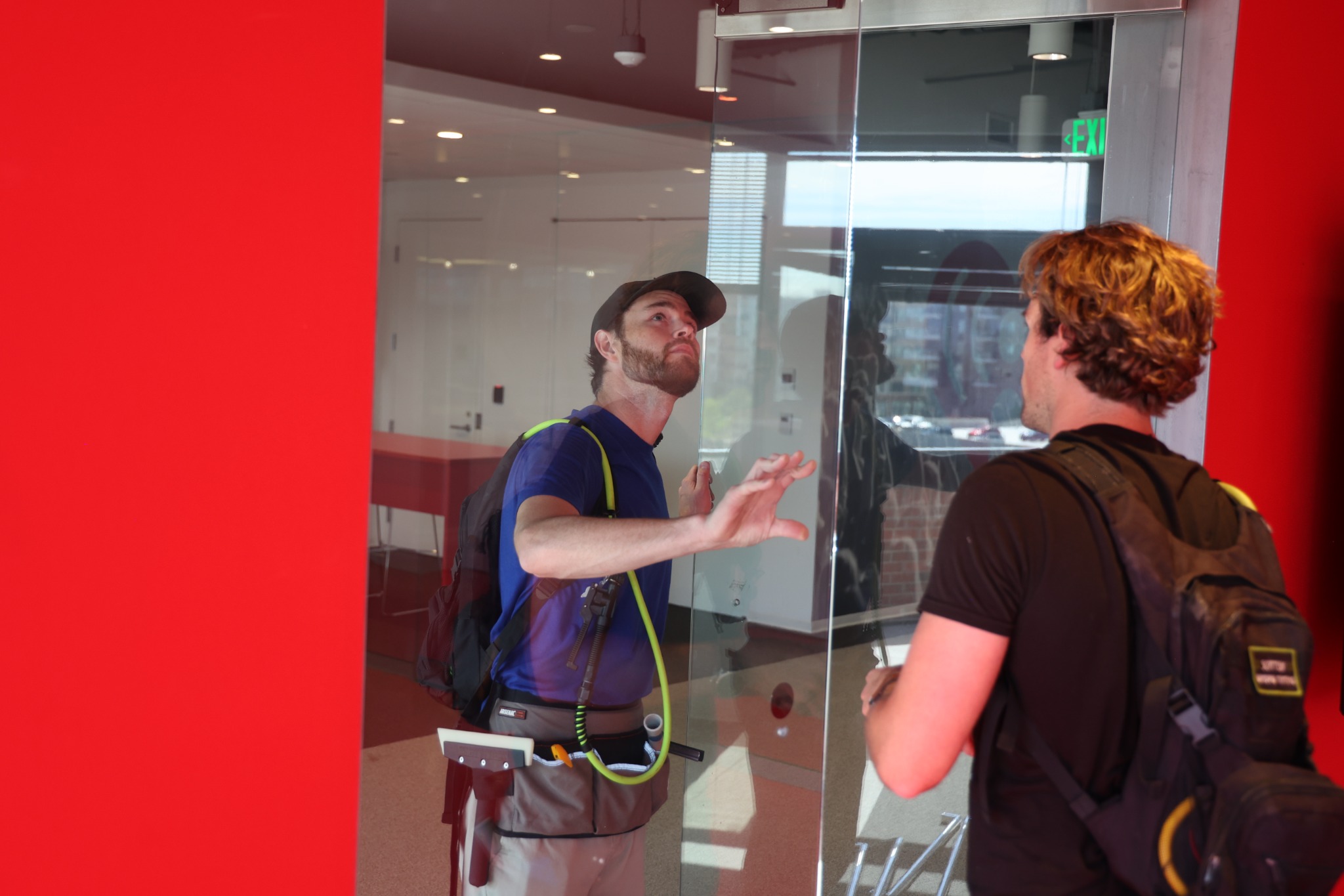 Scottish Window Tinting installers positioning architectural film on interior commercial glass.